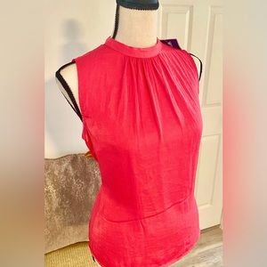 Pink sleeveless top.